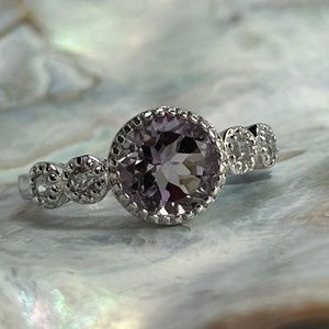 Round amethyst with side white topaz set in sterling silver